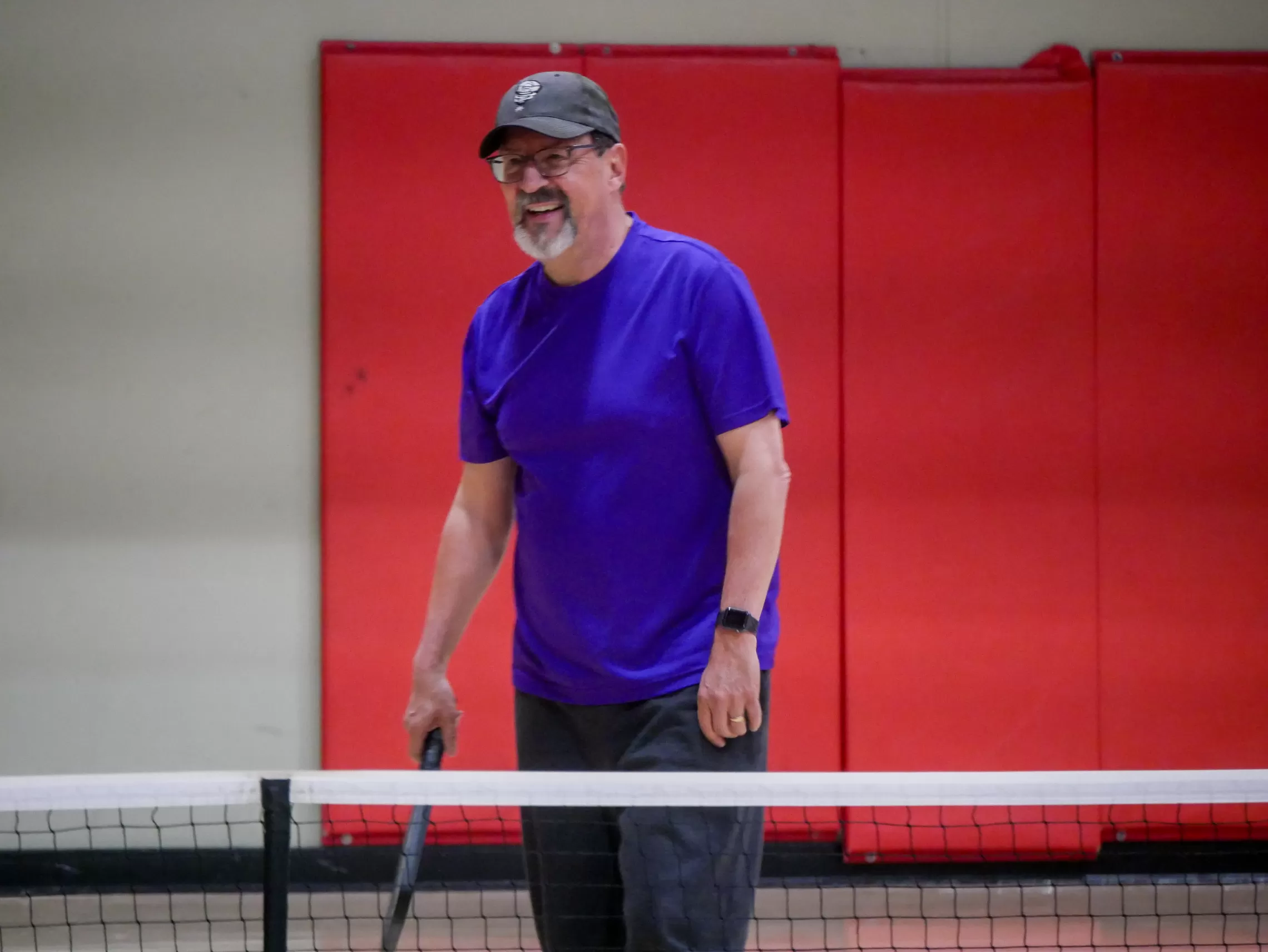 happy man playing pickleball