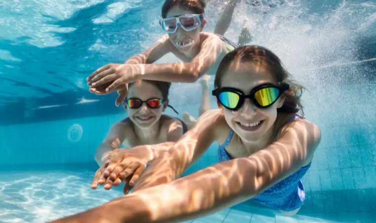3 kids swimming underwater