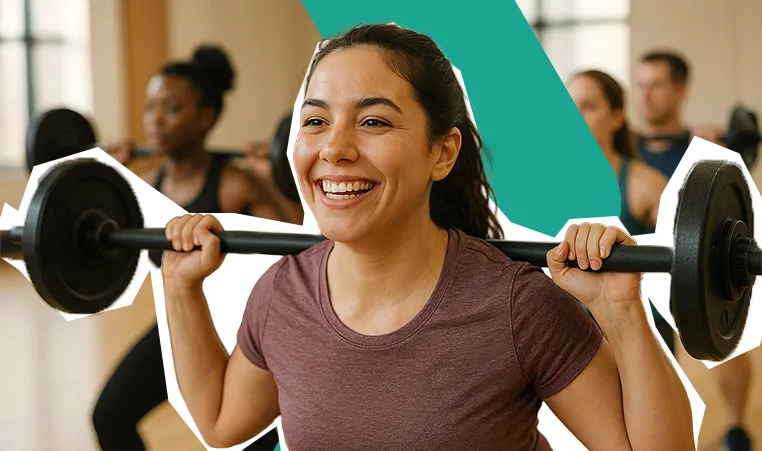 smiling woman lifting a barbell in a group class