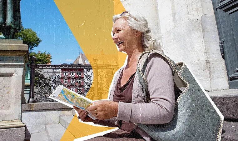 woman sitting on steps looking at a map