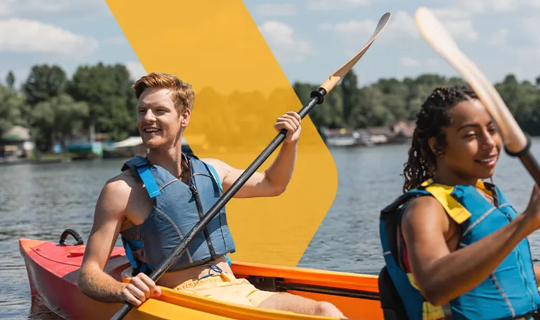 two friends paddling in a canoe