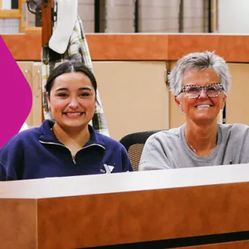 YMCA front desk staff members smiling at the camera