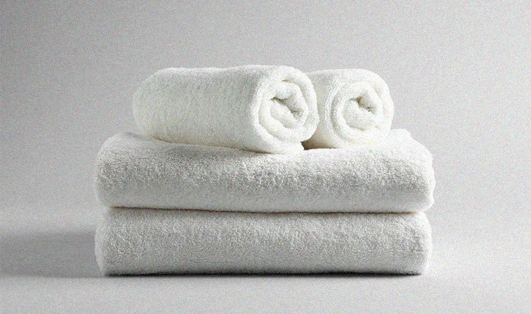 folded white towels on a white background